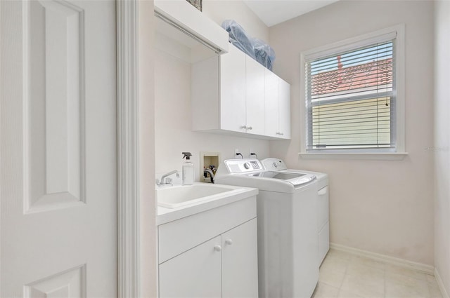 4730 Old Farm Rd, Sarasota, FL 34233 - laundry room with baseboards, washer and clothes dryer, a sink, cabinet space, and light tile patterned floors