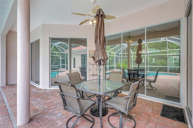 4730 Old Farm Rd, Sarasota, FL 34233 - view of patio / terrace featuring glass enclosure, ceiling fan, outdoor dining space, and an outdoor pool