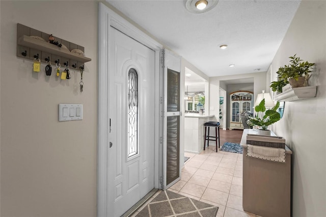 foyer entrance with light tile patterned flooring