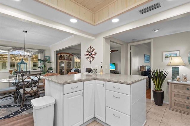 kitchen featuring visible vents, recessed lighting, white cabinetry, and decorative light fixtures