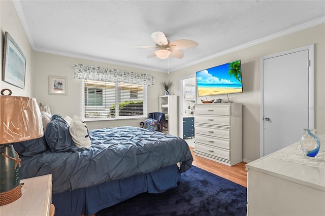 bedroom with crown molding, ceiling fan, and wood finished floors