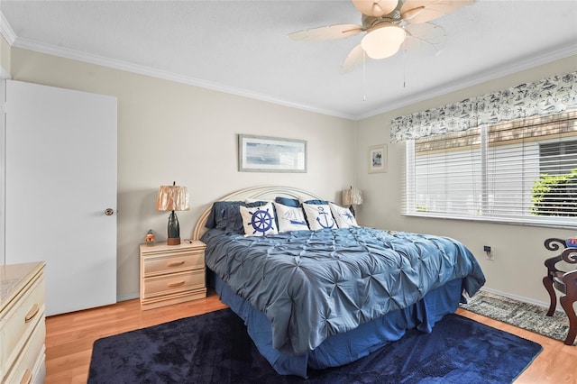 bedroom with ornamental molding, light wood finished floors, and ceiling fan