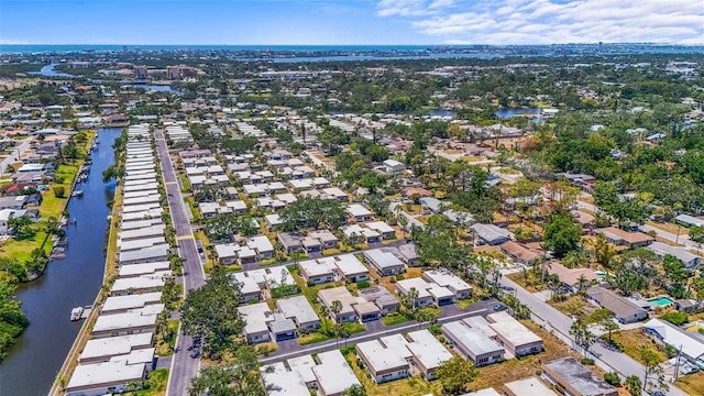 drone / aerial view featuring a residential view and a water view