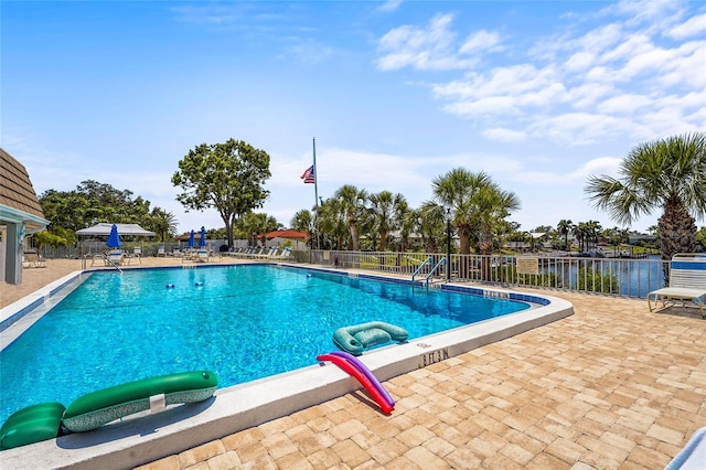community pool featuring a patio and fence