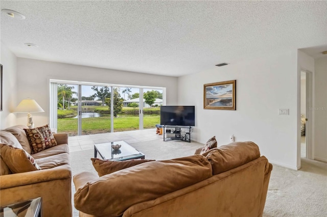 carpeted living room with a textured ceiling and visible vents