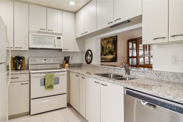kitchen with a sink, light tile patterned floors, white cabinets, recessed lighting, and white appliances