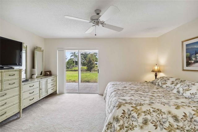 bedroom with access to outside, a textured ceiling, ceiling fan, and light colored carpet