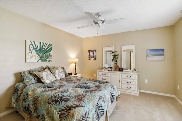 bedroom featuring baseboards, a ceiling fan, and light colored carpet