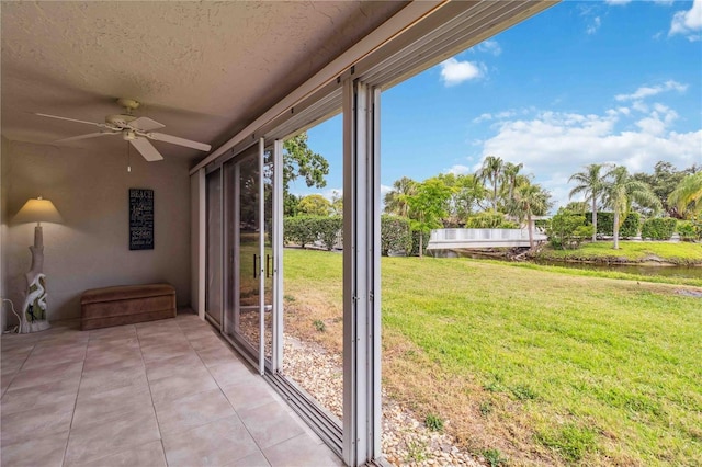 unfurnished sunroom featuring a ceiling fan
