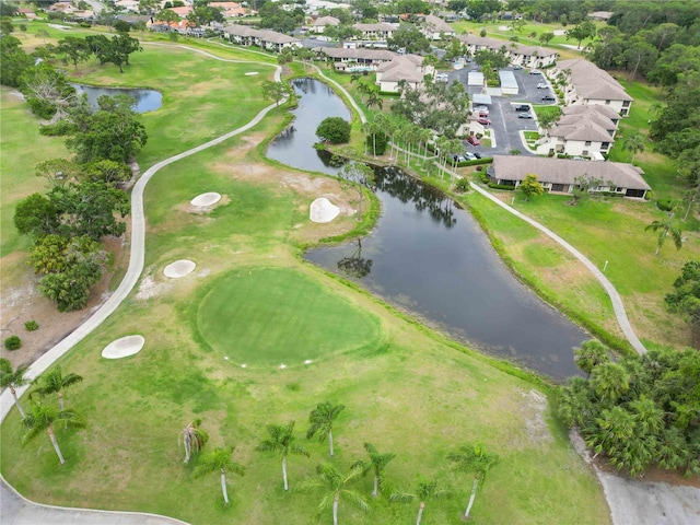 aerial view with view of golf course, a water view, and a residential view