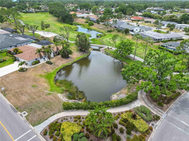 bird's eye view featuring a water view, view of golf course, and a residential view