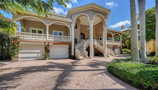 975 Whitakers Ln, Sarasota, FL 34236 - view of front of home featuring stairs, covered porch, decorative driveway, stucco siding, and a garage