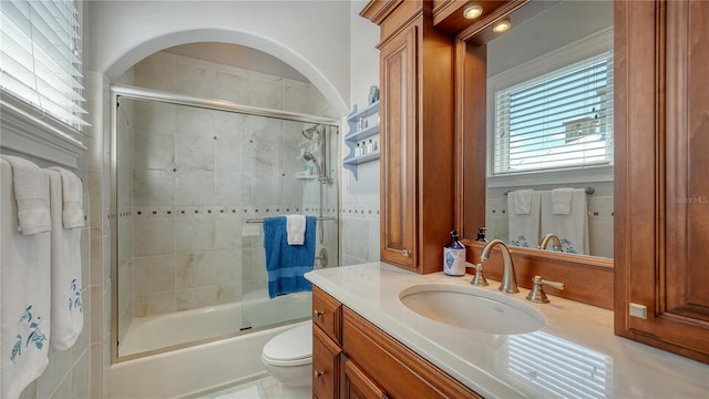 975 Whitakers Ln, Sarasota, FL 34236 - bathroom with vanity, toilet, and enclosed tub / shower combo