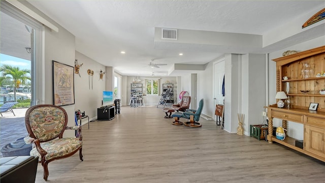 975 Whitakers Ln, Sarasota, FL 34236 - sitting room with light wood-style flooring, recessed lighting, baseboards, a ceiling fan, and a textured ceiling
