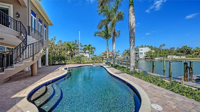 975 Whitakers Ln, Sarasota, FL 34236 - view of swimming pool featuring stairway, a water view, a pool with connected hot tub, and a patio area