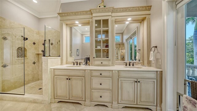 975 Whitakers Ln, Sarasota, FL 34236 - full bathroom with ornamental molding, a tile shower, and double vanity