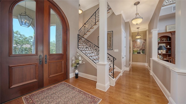 975 Whitakers Ln, Sarasota, FL 34236 - entrance foyer featuring a chandelier, stairs, light wood finished floors, and baseboards