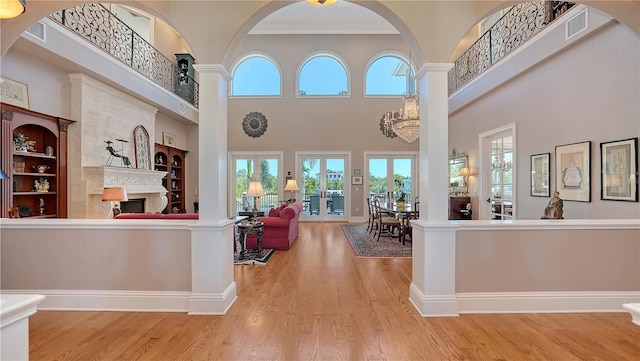 975 Whitakers Ln, Sarasota, FL 34236 - welcome area with a tile fireplace, a towering ceiling, and ornamental molding