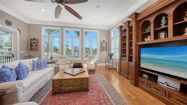 975 Whitakers Ln, Sarasota, FL 34236 - living room featuring light wood-style flooring, ornamental molding, healthy amount of natural light, ceiling fan, and recessed lighting