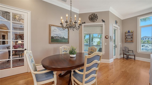 975 Whitakers Ln, Sarasota, FL 34236 - dining room with light wood-style floors, a chandelier, plenty of natural light, crown molding, and baseboards