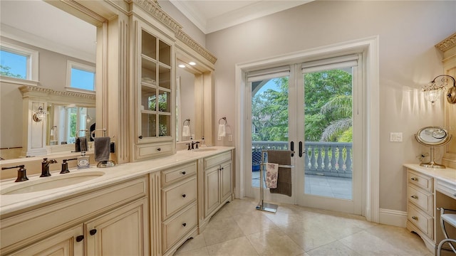 975 Whitakers Ln, Sarasota, FL 34236 - bathroom with french doors, double vanity, ornamental molding, tile patterned floors, and baseboards