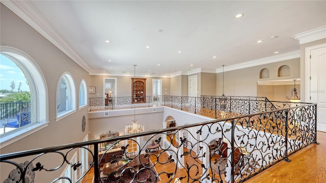 975 Whitakers Ln, Sarasota, FL 34236 - corridor featuring recessed lighting, wood finished floors, a chandelier, crown molding, and an upstairs landing