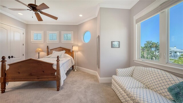975 Whitakers Ln, Sarasota, FL 34236 - bedroom featuring multiple windows, light colored carpet, baseboards, ceiling fan, and ornamental molding