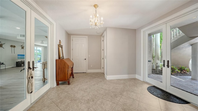975 Whitakers Ln, Sarasota, FL 34236 - doorway to outside featuring french doors, a chandelier, baseboards, and light tile patterned flooring