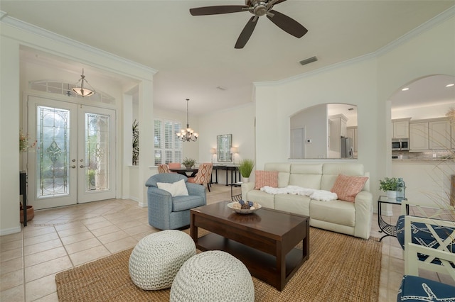 living area with visible vents, crown molding, french doors, ceiling fan with notable chandelier, and light tile patterned floors