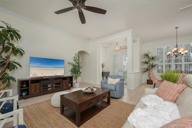 living area featuring french doors, arched walkways, ceiling fan with notable chandelier, ornamental molding, and light tile patterned flooring