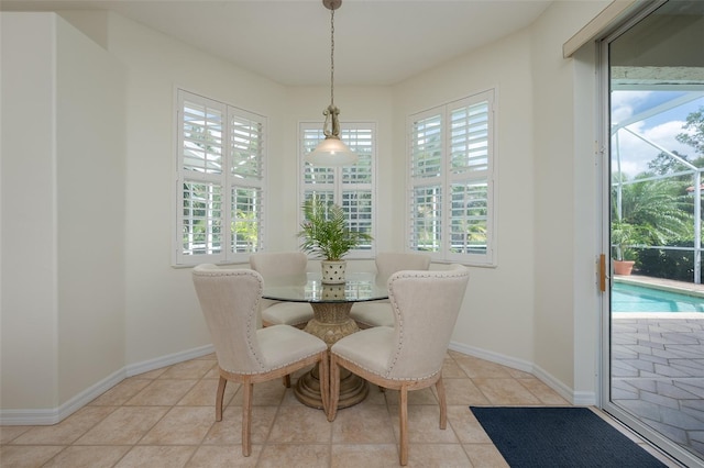 dining room with light tile patterned flooring, baseboards, and plenty of natural light