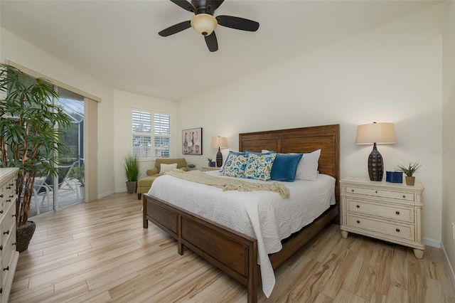 bedroom featuring baseboards, access to exterior, and light wood-style flooring