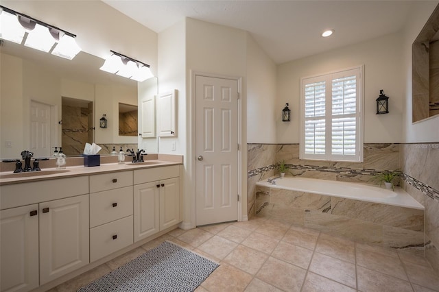 bathroom with double vanity, walk in shower, a sink, and a bath