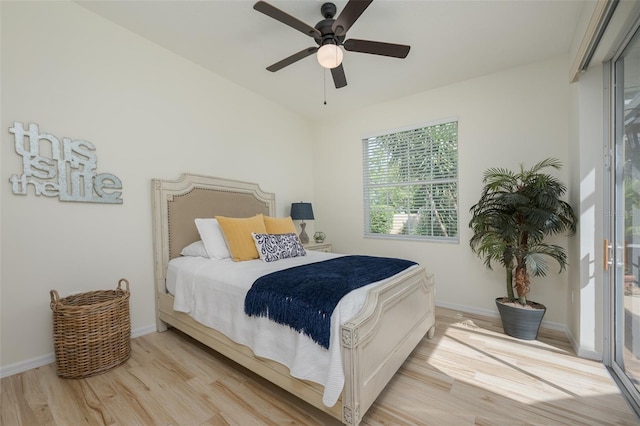 bedroom featuring baseboards, ceiling fan, and light wood-style flooring