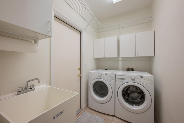 laundry room with a sink, separate washer and dryer, light tile patterned floors, and cabinet space