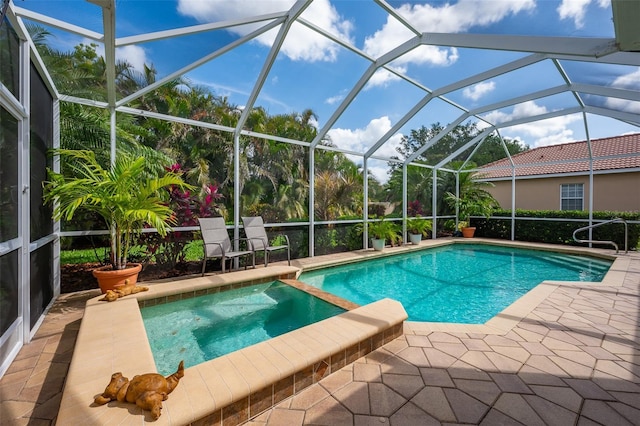 view of swimming pool with a patio and a pool with connected hot tub