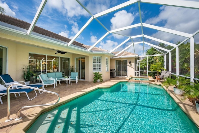view of pool with a patio, outdoor lounge area, and a lanai