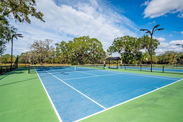 view of sport court featuring fence