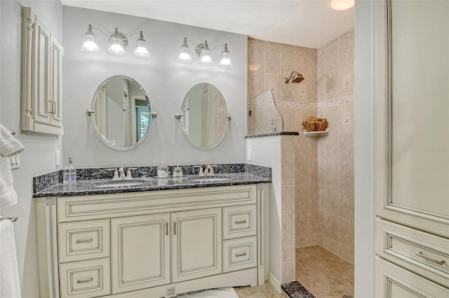 bathroom with double vanity, walk in shower, and a sink