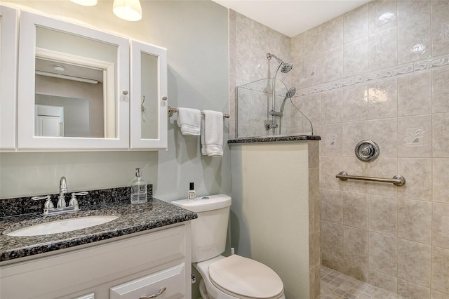 full bathroom with vanity, walk in shower, and toilet
