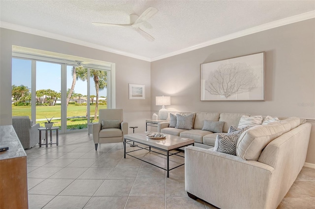 living room with ceiling fan, ornamental molding, light tile patterned flooring, and a textured ceiling