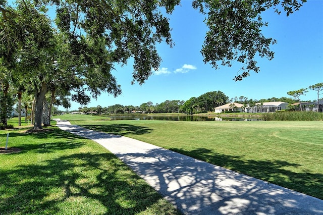 surrounding community featuring a yard and a water view