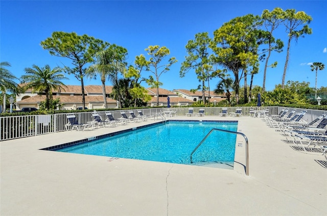 community pool featuring a patio area and fence