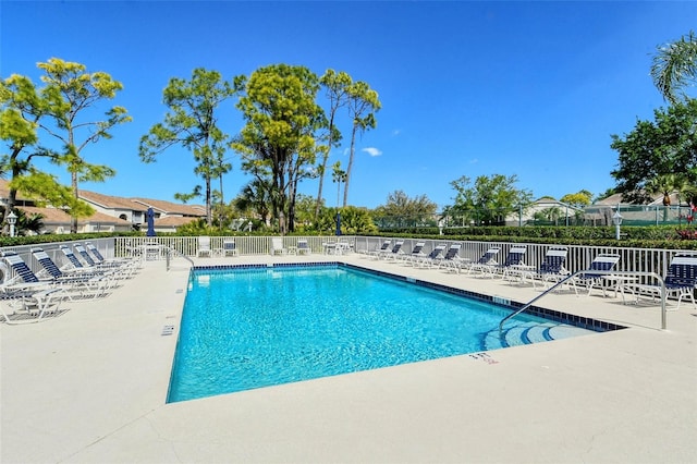 community pool featuring a patio and fence