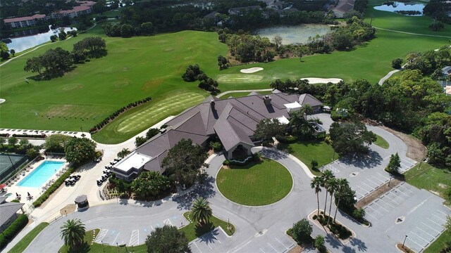 drone / aerial view with a water view and view of golf course