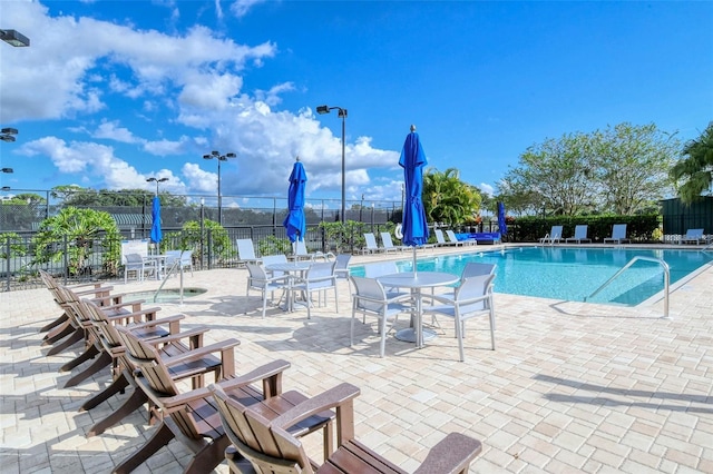 pool featuring a patio and fence