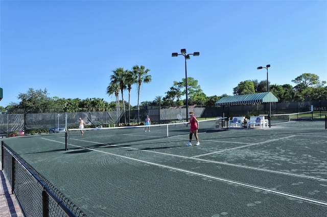 view of sport court featuring fence