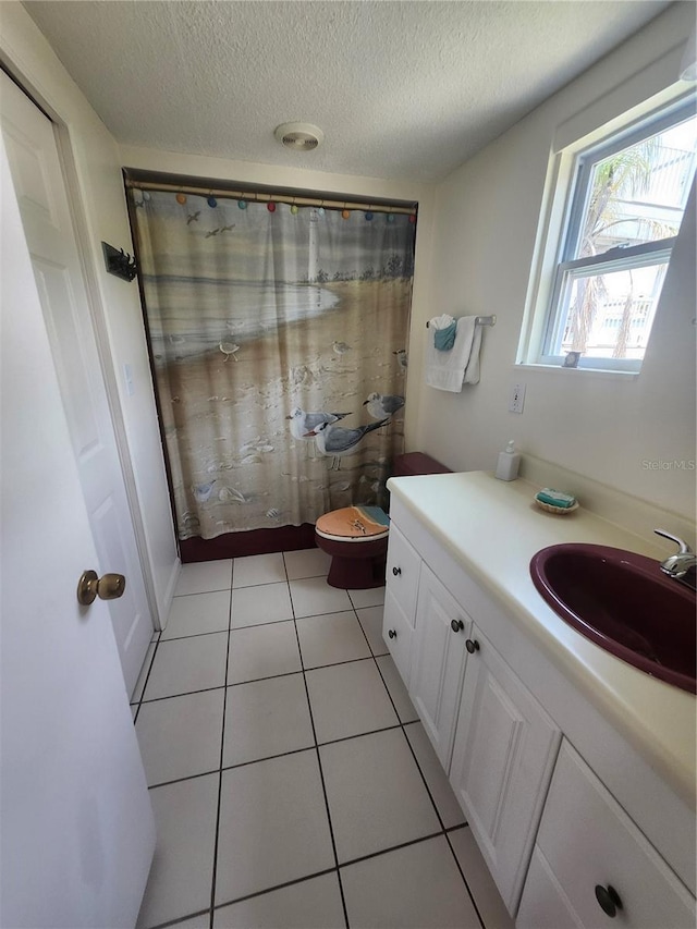full bathroom featuring vanity, a textured ceiling, a shower with shower curtain, tile patterned floors, and toilet