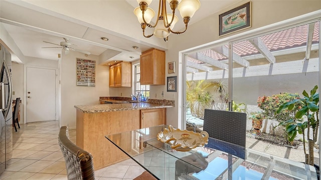 3984 Lyndhurst Ct, Sarasota, FL 34235 - dining area featuring light tile patterned floors and ceiling fan with notable chandelier