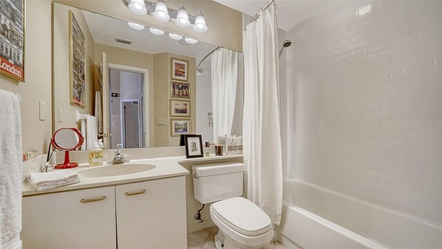 3984 Lyndhurst Ct, Sarasota, FL 34235 - full bathroom featuring visible vents, tile patterned flooring, shower / bath combo, vanity, and toilet